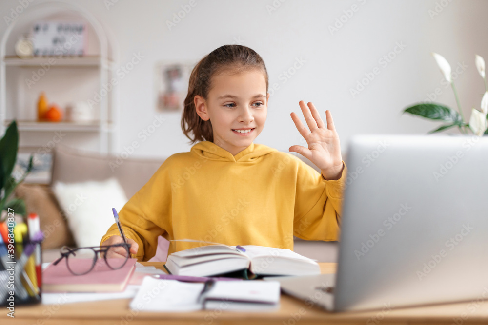 Smiling little Caucasian girl having video call distant class with school teacher, using laptop, waving hand, greeting personal tutor, studying online on computer. Homeschooling and distance education Smiling little Caucasian girl having video call distant class with school teacher, using laptop, waving hand, greeting personal tutor, studying online on computer. Homeschooling and distance education