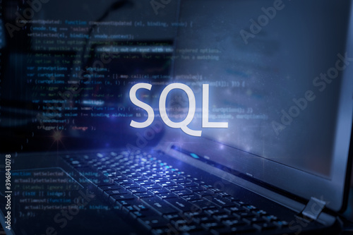SQL inscription against laptop and code background. Learn sql programming language, computer courses, training. photo