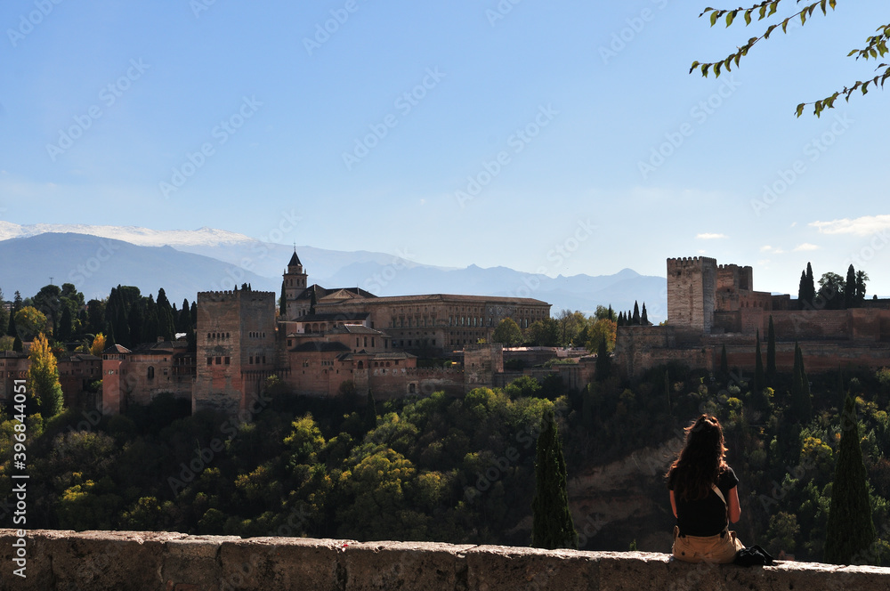 Alhambra palace, snow covered peaks of the Sierra Nevada in bright sunlight during Covid-19-autumn 2020
