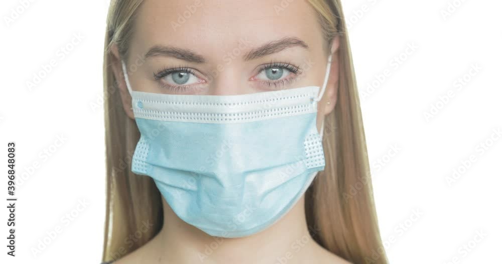 Close-up portrait of a blonde woman wearing medical PPE. Close-up portrait of a blonde woman wearing medical PPE.