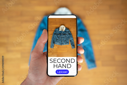 фотографія View of a person taking a photo of a jacket to upload in a second hand clothes a