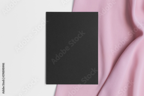 Black invitation card mockup with a soft pink textile. 5x7 ratio, similar to A6, A5.