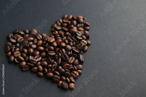 roasted coffee beans heart on black background