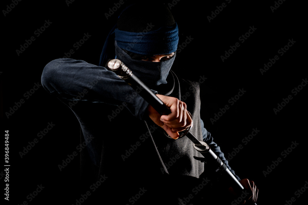 Ninja warrior in the dark with sword Ninja warrior in the dark with sword