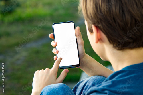 Boy holding the black smartphone blank screen with modern framel photo