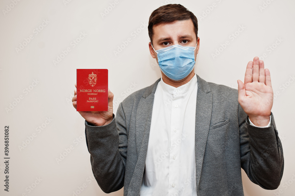 European man in formal wear and face mask, show Norway passport with stop  sign hand. Coronavirus lockdown in Europe country concept. Stock 写真 | Adobe  Stock