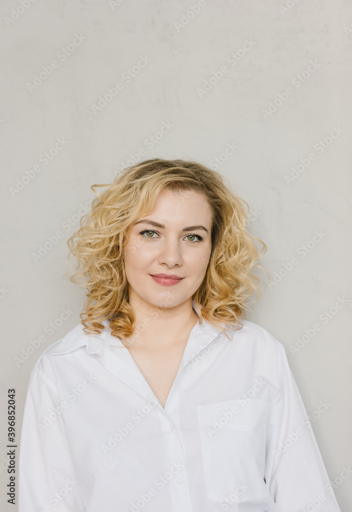 Portrait of a beautiful young woman in a white shirt. Portrait of a beautiful young woman in a white shirt.
