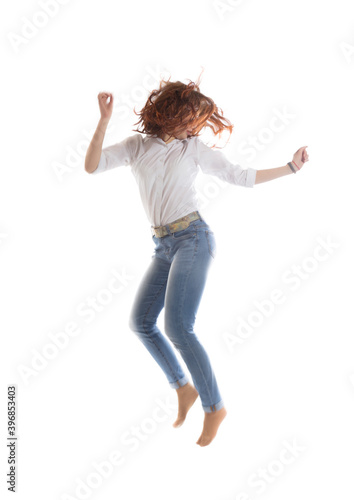 Teenage long hair girl jumping on white background.