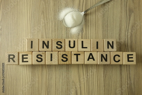 Text insulin resistance from wooden blocks with spoon of sugar
