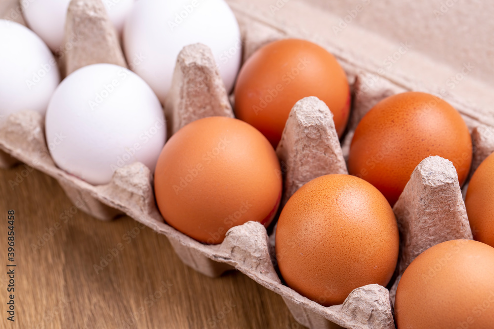 Chicken brown fresh raw eggs in an egg container. Ingredients for cooking. Healthy eating is a concept. Horizontal orientation, selective focus. Chicken brown fresh raw eggs in an egg container. Ingredients for cooking. Healthy eating is a concept. Horizontal orientation, selective focus.