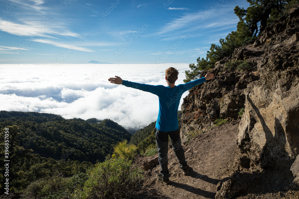 happy man above the clouds travelling on Canary Island La Palma
