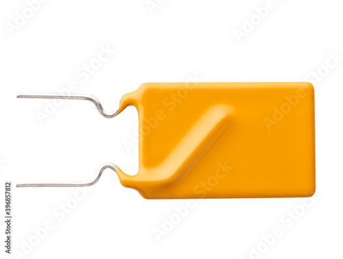 Yellow rectangular polyester film capacitor isolated. Electronic components. Close-up. Top view.  photo