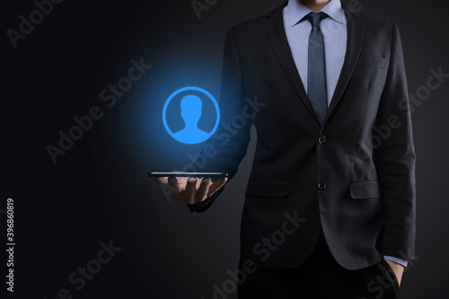 Businessman in suit holding out hand icon of user. Internet icons interface foreground. global network media concept,contact on virtual screens ,copy space