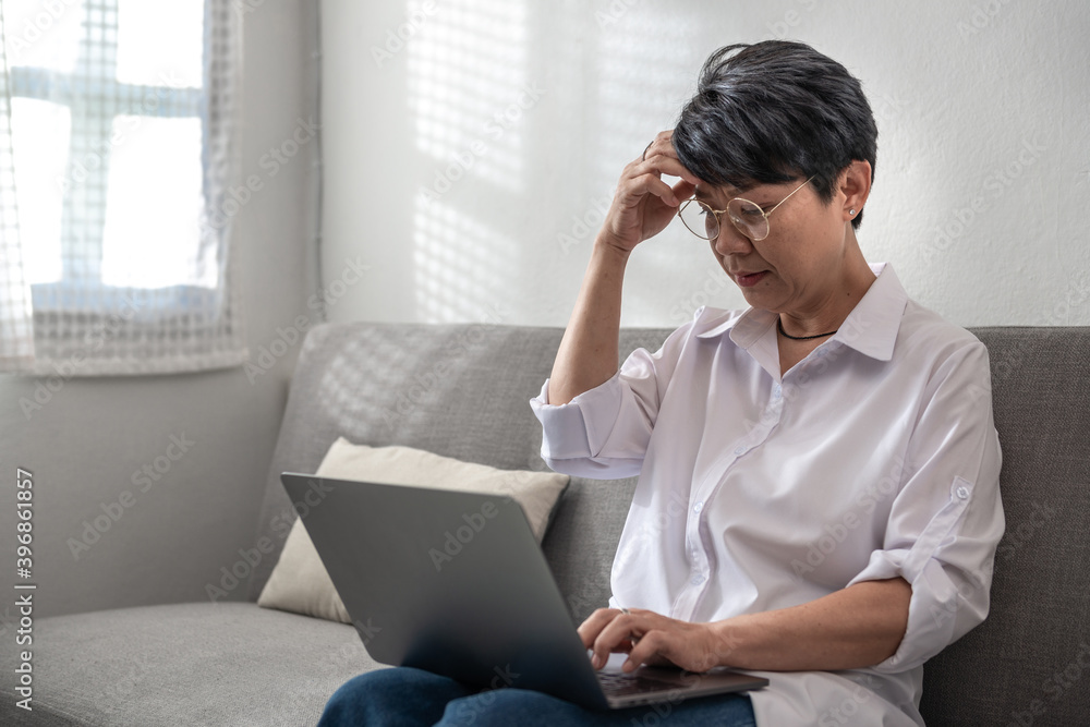 Senior Asian businesswoman is stressed, does not understand, or has problems while working on a laptop at home. Learning ideas for elderly knowledge of internet and technology skills Senior Asian businesswoman is stressed, does not understand, or has problems while working on a laptop at home. Learning ideas for elderly knowledge of internet and technology skills