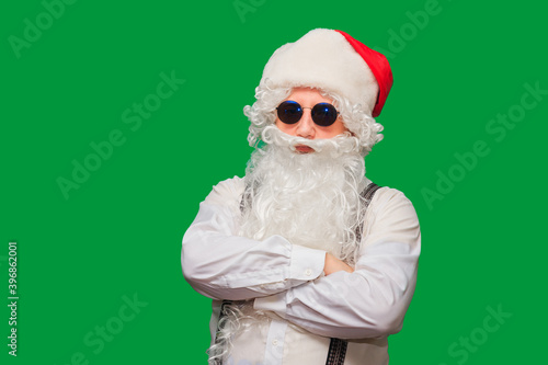 Portrait of stylish Santa Claus on color background.