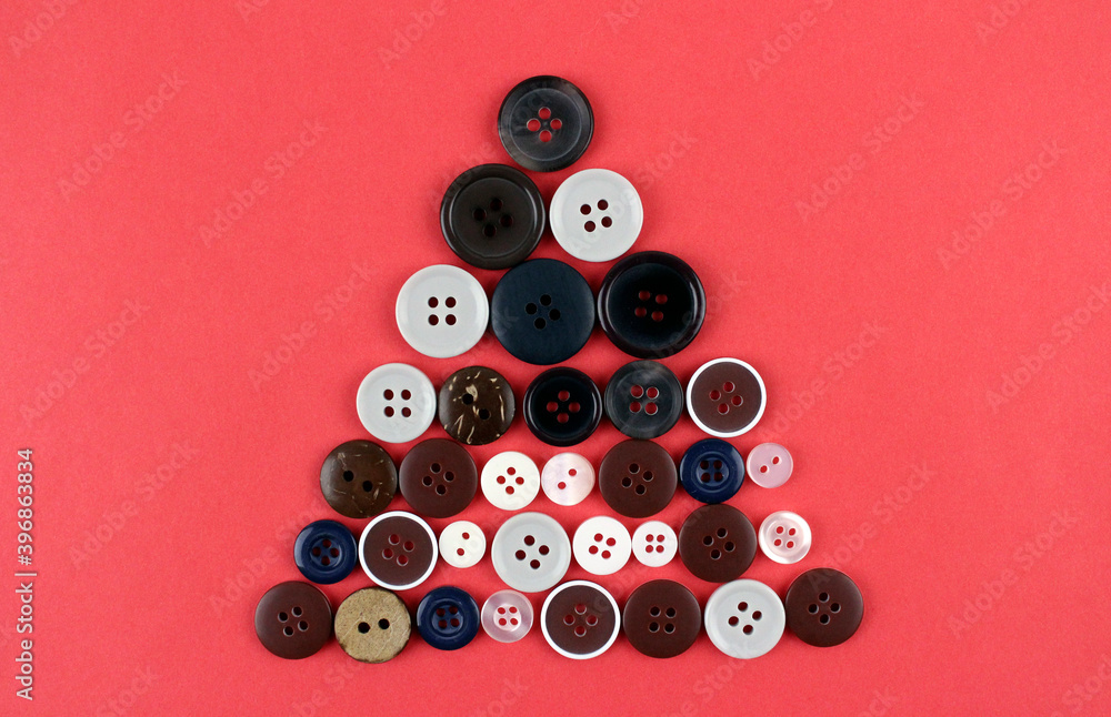 New Year tree made of various round buttons on a red background. Christmas, new year, creative New Year tree made of various round buttons on a red background. Christmas, new year, creative