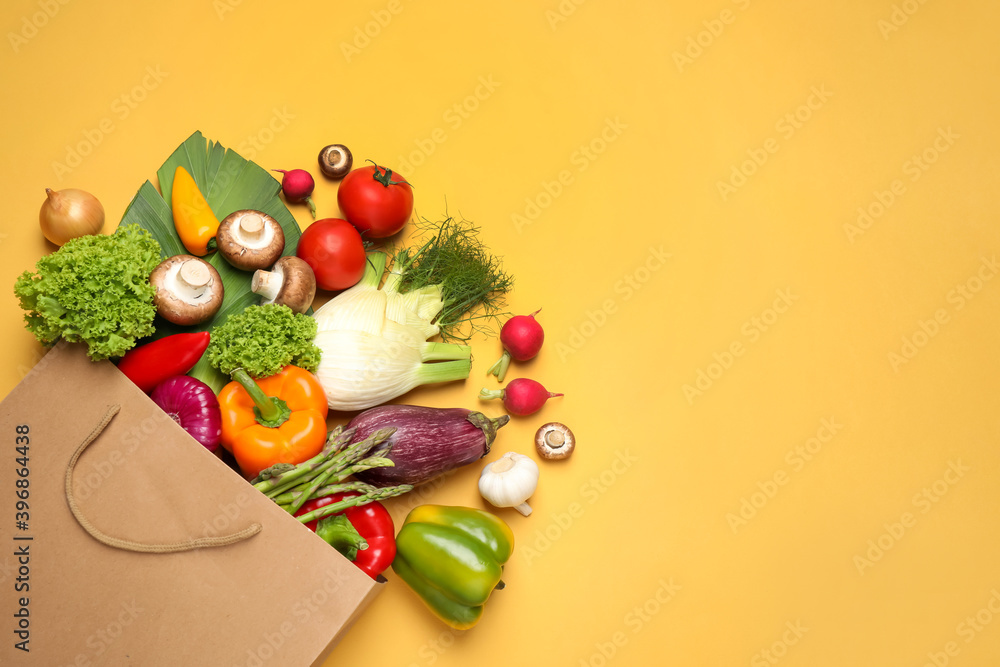 Different fresh vegetables on yellow background, flat lay. Space for text