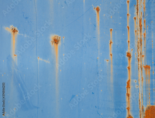 Old metallic blue wall with rust
