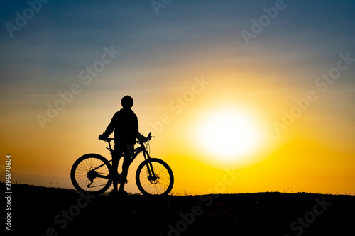 The moment of the cyclist enjoying nature watching the sunrise © emerald_media