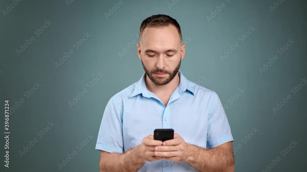 Focused trendy business man chatting use smartphone isolated. Medium shot on RED camera Focused trendy business man chatting use smartphone isolated. Medium shot on RED camera