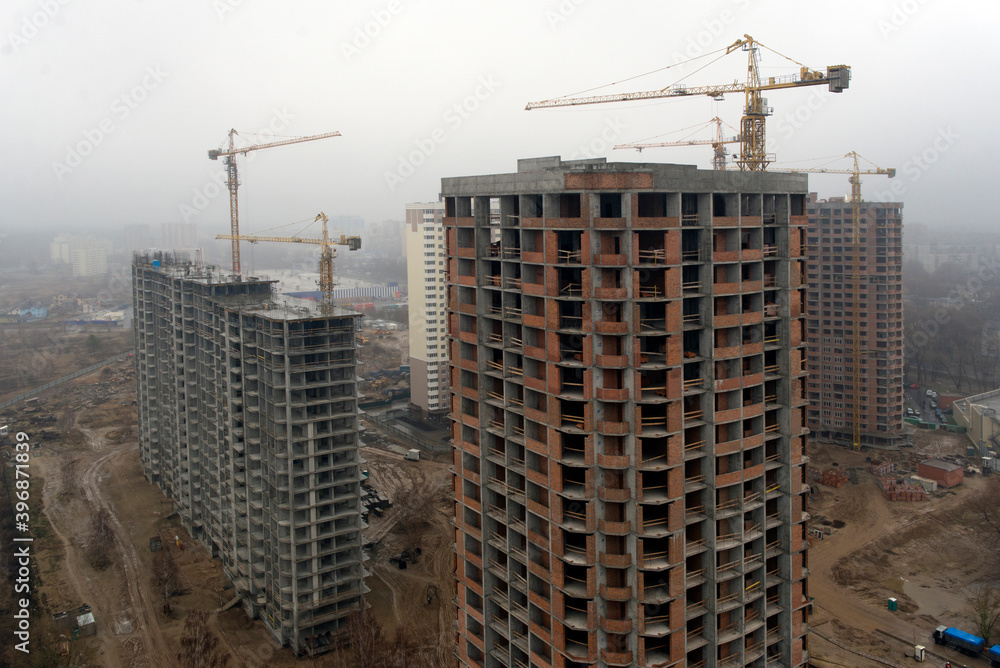 Winter, construction site, tower crane production of social housing.