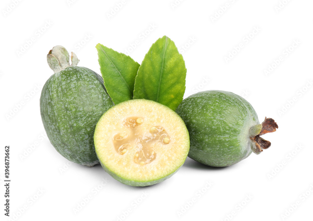 Cut and whole feijoas with leaves on white background