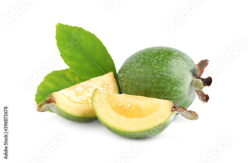 Cut and whole feijoas with leaves on white background