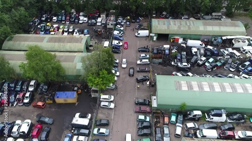 Aerial bird view of wrecking yard or scrapyard junkyard is location of business in dismantling where wrecked or decommissioned vehicles are brought and usable parts are sold for operating automobiles
