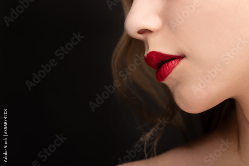 Studio shot of a young girl wearing red lipstick