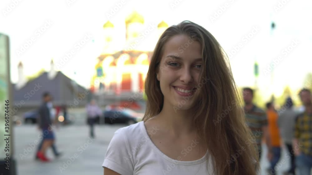 Beautiful girl with a smile on the background of the city Beautiful girl with a smile on the background of the city