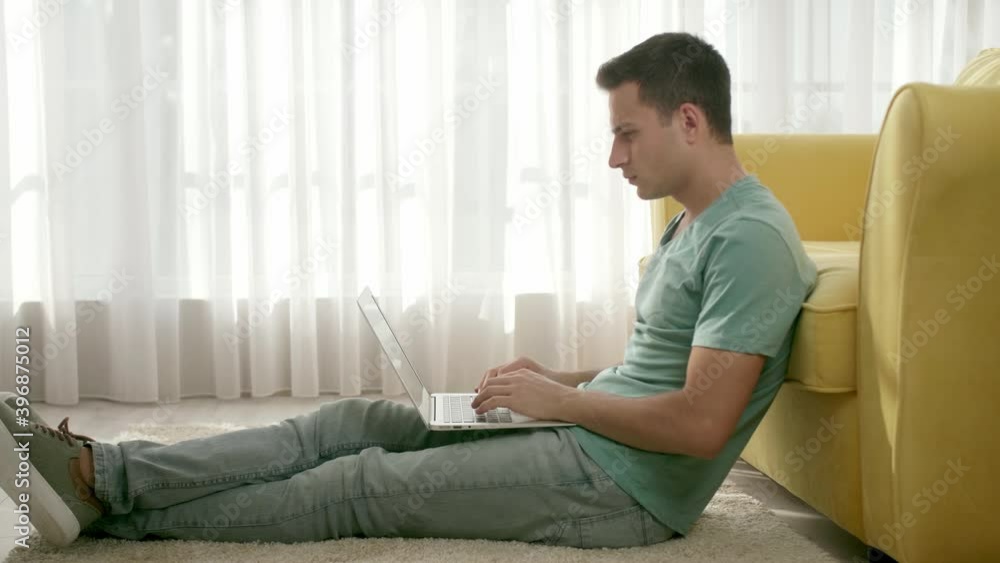 Young man working on laptop at home Young man working on laptop at home