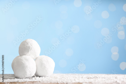 Snowballs on table against blurred lights, space for text