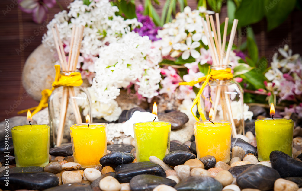 Aromatherapy, spa, beauty treatment and wellness background with massage stone, flowers, burning candles... spa concept
