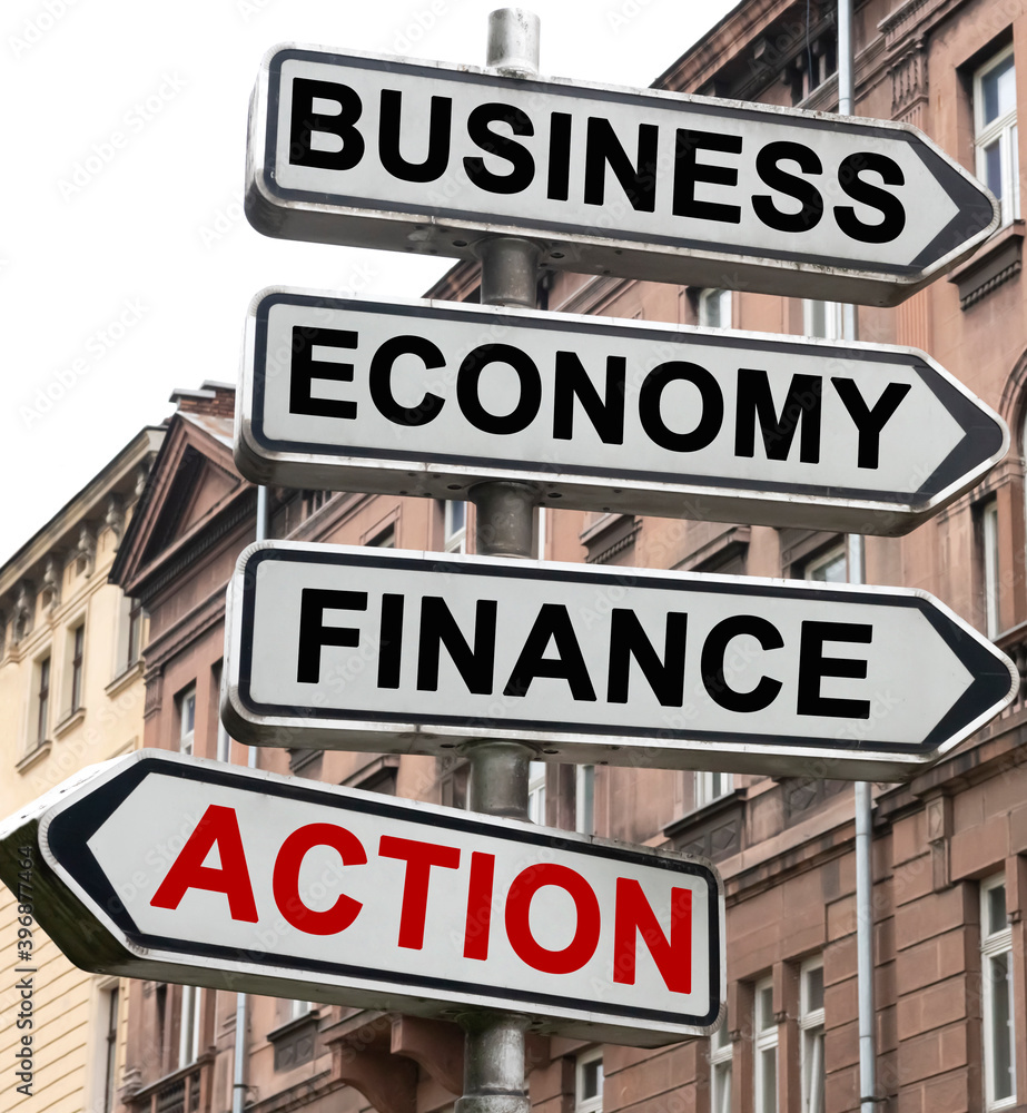 The road indicator on the arrows of which is written - business, economics, finance and ACTION The road indicator on the arrows of which is written - business, economics, finance and ACTION