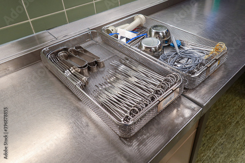 in the sterilization department of a hospital, cleaned and disinfected instruments lie in trays
