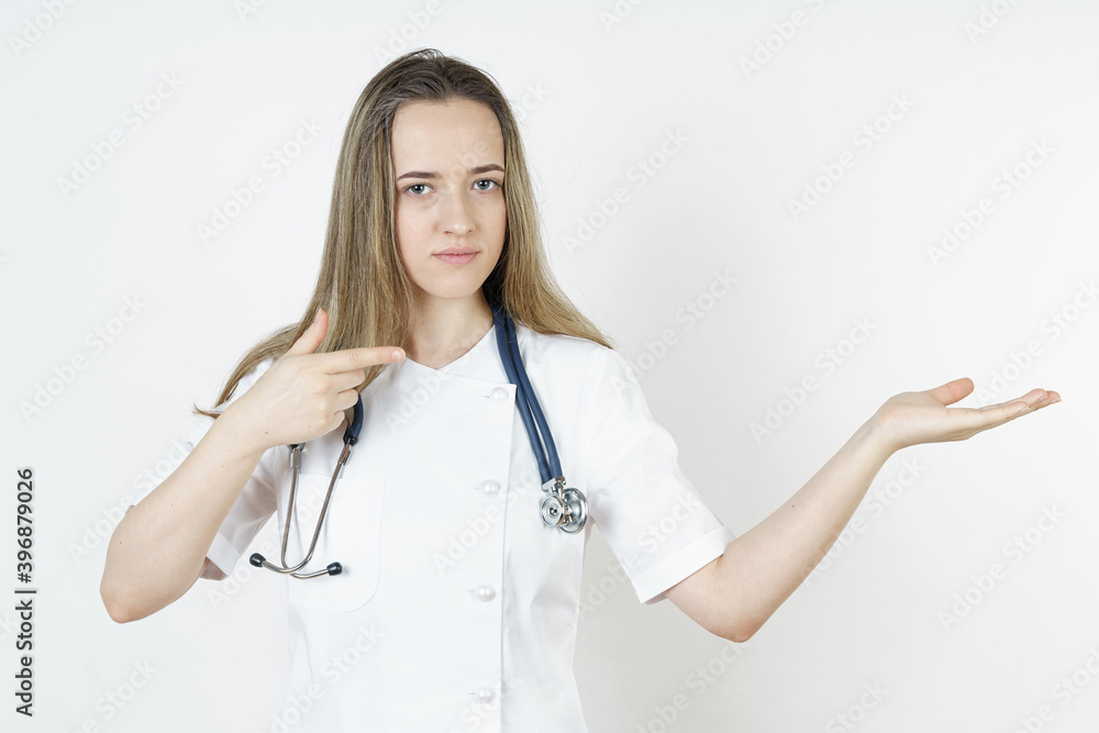 Medicine and health concept. Doctor pointing with his hands to the side and looking at the camera. Medicine and health concept. Doctor pointing with his hands to the side and looking at the camera.