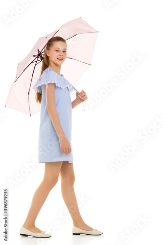 Pretty Teen Girl Walking under Umbrella Against White Background