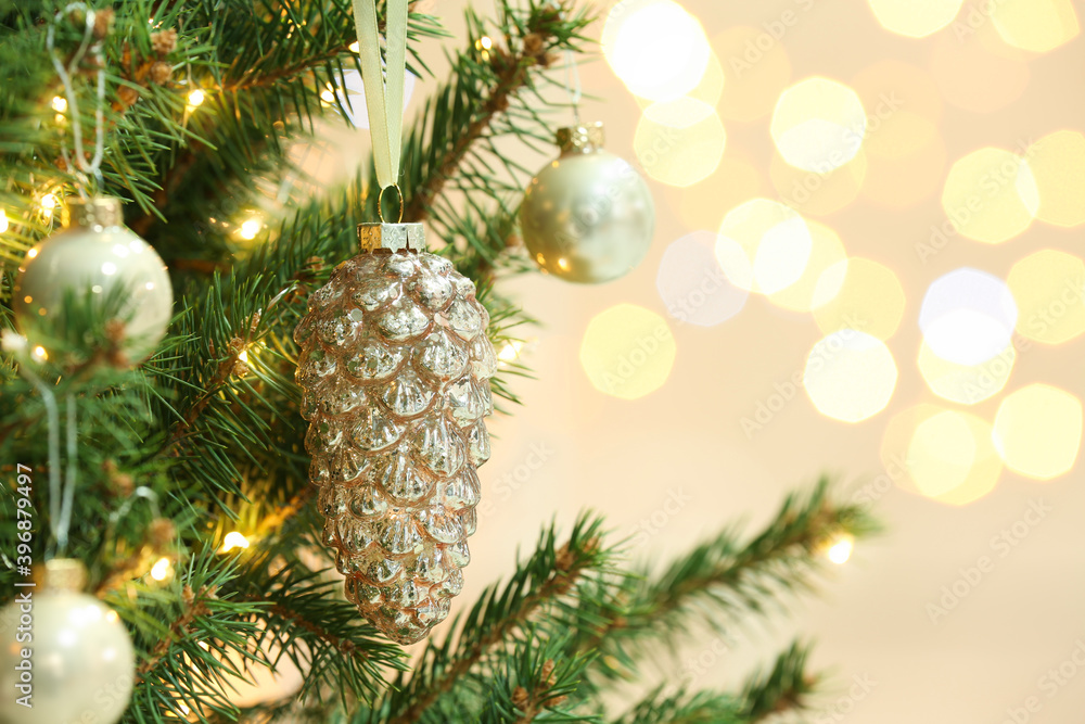 Cone shaped holiday bauble hanging on Christmas tree against blurred lights, closeup. Space for text Cone shaped holiday bauble hanging on Christmas tree against blurred lights, closeup. Space for text