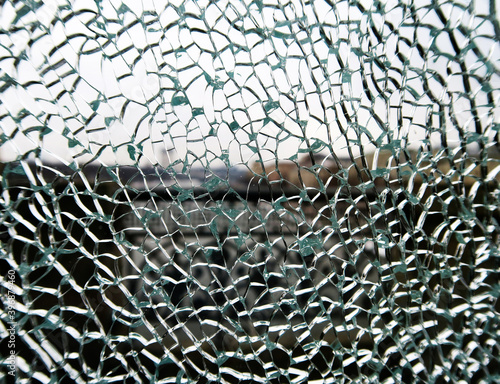 Fotografi cracks on broken tempered glass exterior, outdoor background
