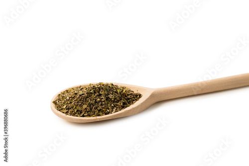 Oregano spice in wooden spoon isolated.