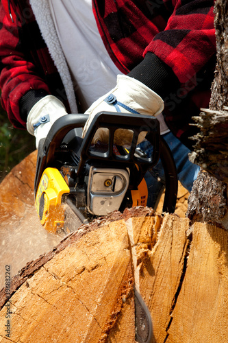 Close-up view of lumberjack with electric saw