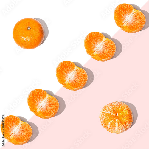 Fruit pattern mandarins isolated on blue or mint background, top view.