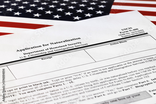 selective focus photo of n-400 form. application for naturalization, on a background of United States flag.