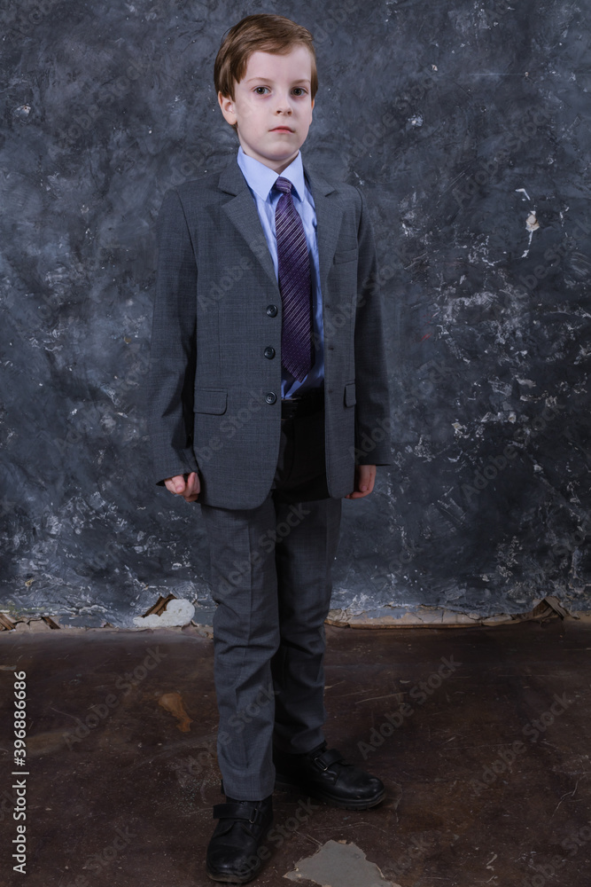 Cute schoolboy dressed in suit studio portrait. Cute schoolboy dressed in suit studio portrait.