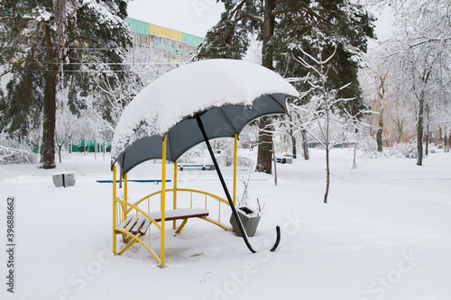 Gazebo trees and Playground in the snow. The Blizzard brought a lot of snow and snow drifts. Winter city.