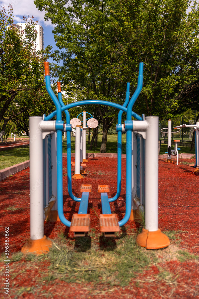 Sports equipment made of plastic and metal produced for sports and fitness in the garden in daylight Sports equipment made of plastic and metal produced for sports and fitness in the garden in daylight