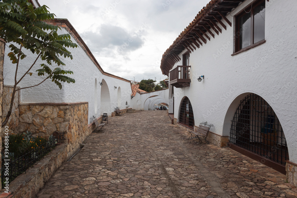 Guatavita colombian town alley autumn scene with colonial architecture and white cloudy day