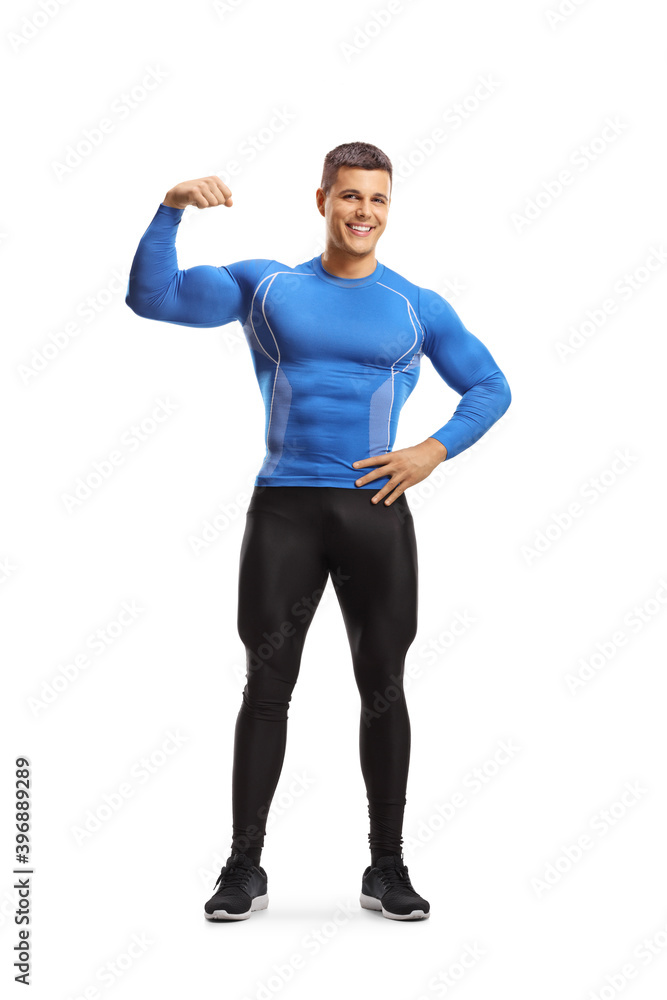 Full length portrait of a fit muscular man in leggings flexing arm muscles Full length portrait of a fit muscular man in leggings flexing arm muscles