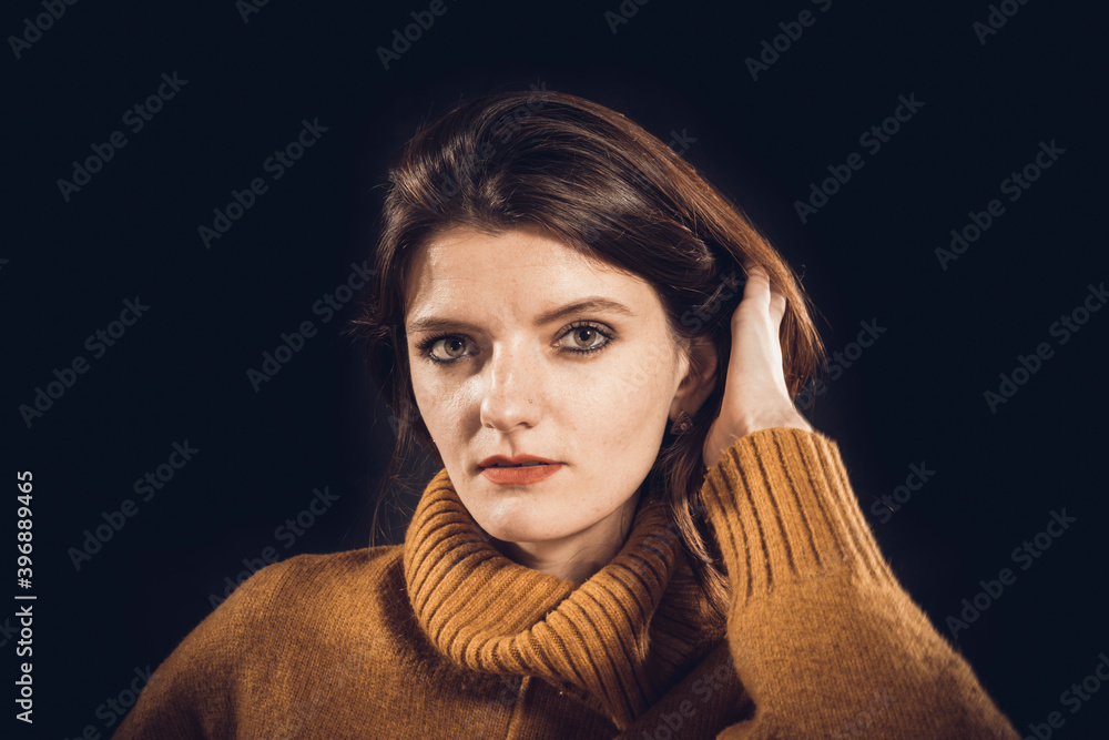 Studio portrait of young beautiful woman dressed in sweater Studio portrait of young beautiful woman dressed in sweater