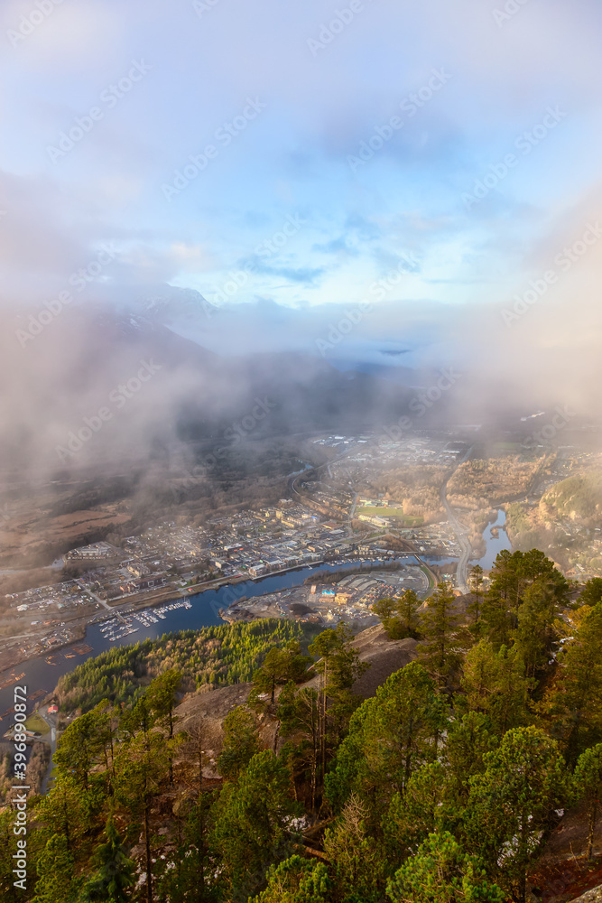 Aerial View of Squamish City during a sunny sunset. Taken from Chief Mountain, near Vancouver, British Columbia, Canada.